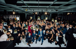 Large group of restaurant and catering professionals gathered on stage at the Restaurant & Catering Hostplus Awards for Excellence, celebrating industry achievement and teamwork.